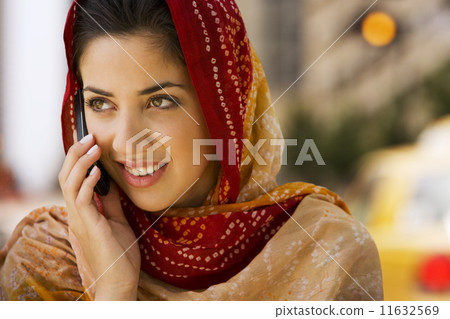 Middle Eastern woman talking on cell phone Middle Eastern woman talking on cell phone 11632569