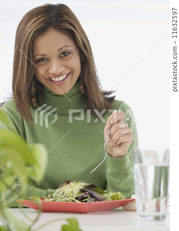 Indian woman eating salad Indian woman eating salad 11632597