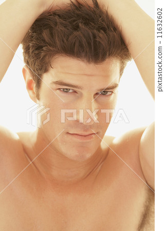 Bare-chested man with hands in hair 11632602