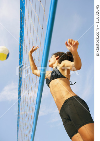 Young woman playing volleyball Young woman playing volleyball 11632645