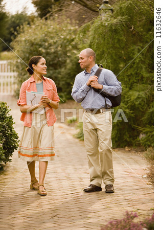 Hispanic couple walking in park 11632646