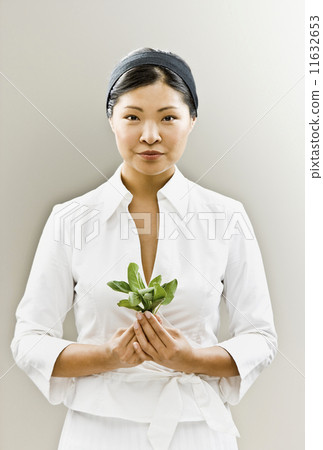 Asian woman holding flower 11632653