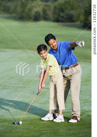 Hispanic father helping daughter play golf 11632716