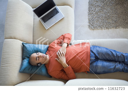 African American man listening to headphones 11632723