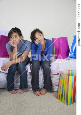 African twin sisters looking bored African twin sisters looking bored 11632753