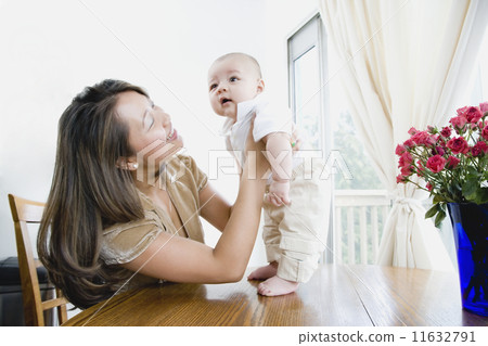 Asian mother smiling at baby 11632791