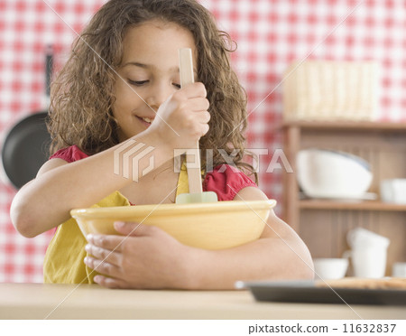 Young girl mixing batter in kitchen Young girl mixing batter in kitchen 11632837