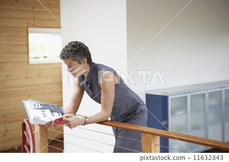 Mixed Race businesswoman reading paperwork  11632843