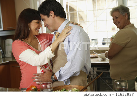 Pregnant Hispanic couple hugging Pregnant Hispanic couple hugging 11632957