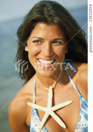 Young woman wearing starfish necklace 11632959