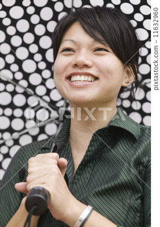 Asian woman carrying umbrella Asian woman carrying umbrella 11632960