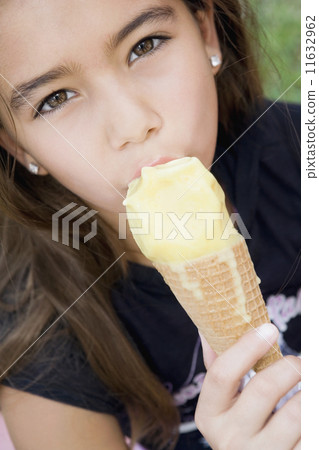 Hispanic girl eating ice cream cone Hispanic girl eating ice cream cone 11632962