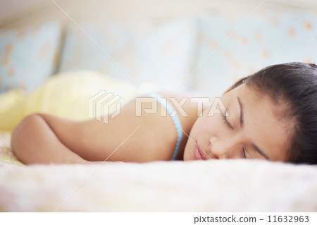 Young woman asleep in bed Young woman asleep in bed 11632963