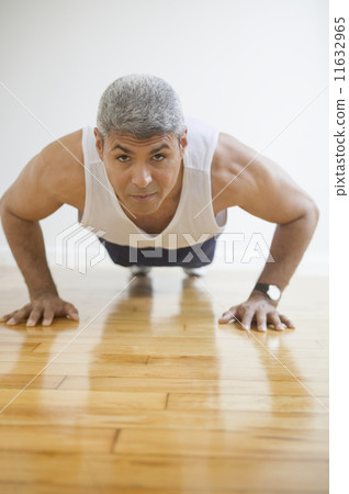 Middle aged man doing push ups 11632965