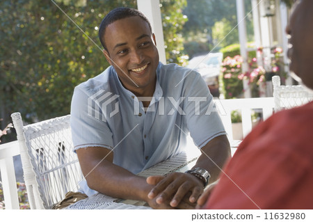 African American man sitting on porch 11632980
