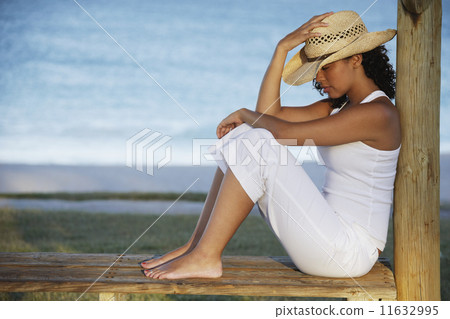 Mixed Race woman wearing straw hat Mixed Race woman wearing straw hat 11632995