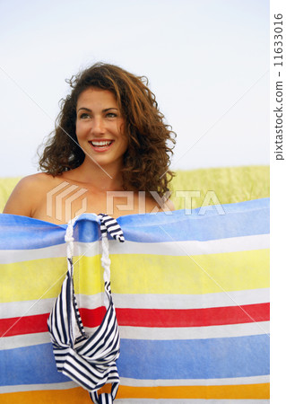 Woman changing behind screen in field Woman changing behind screen in field 11633016