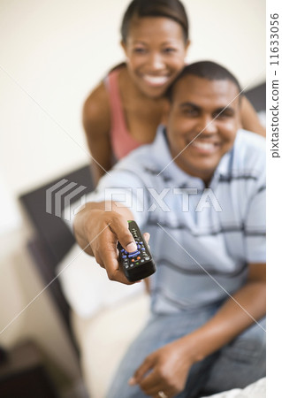African couple watching television 11633056