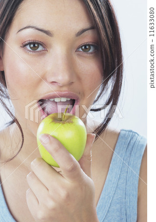 Young woman eating apple Young woman eating apple 11633080