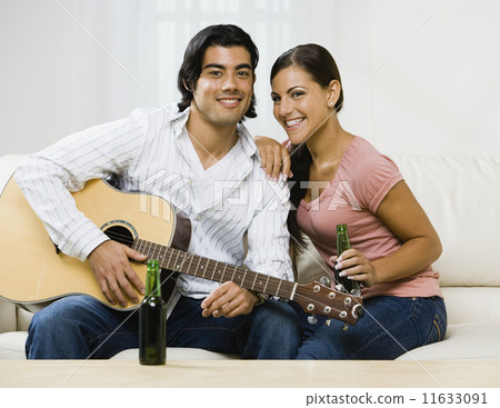 Multi-ethnic couple with guitar 11633091