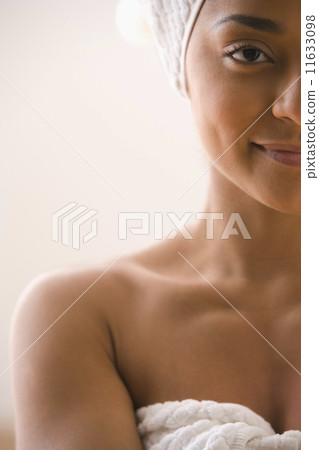 Close up of woman wearing towel around body and head 11633098