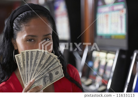 Hispanic woman holding money 11633113