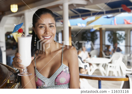 Hispanic woman holding cocktail 11633116