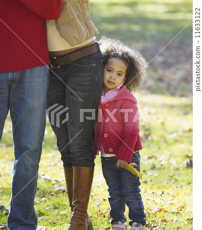 African girl hugging mother's legs 11633122