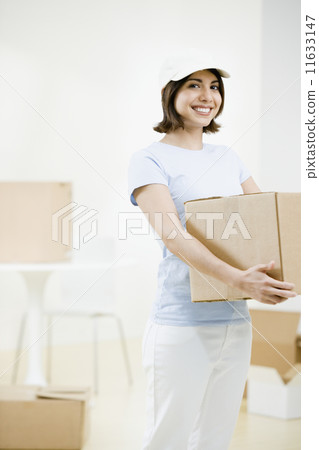 Mixed Race woman carrying moving box Mixed Race woman carrying moving box 11633147