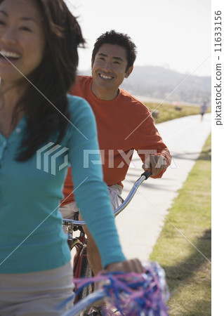 Asian couple riding bicycles 11633156