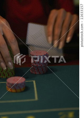 Close up of Hispanic woman gambling 11633157