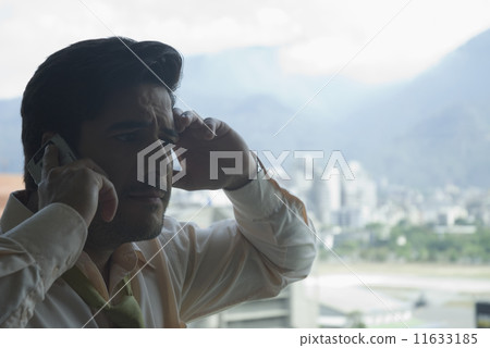 Hispanic businessman talking on cell phone 11633185