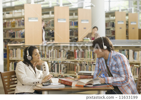 Multi-ethnic couple studying in library 11633199
