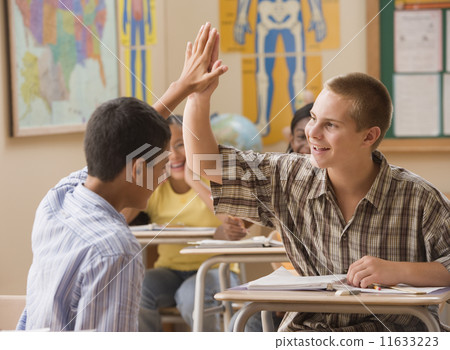 Students high fiving in class 11633223