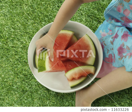 Young girl holding a bowl of watermelon 11633226