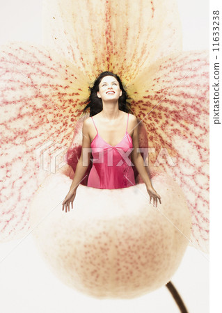 Young woman standing in a giant flower 11633238