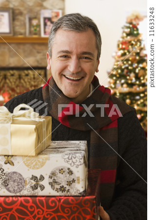 Caucasian man holding Christmas gifts Caucasian man holding Christmas gifts 11633248