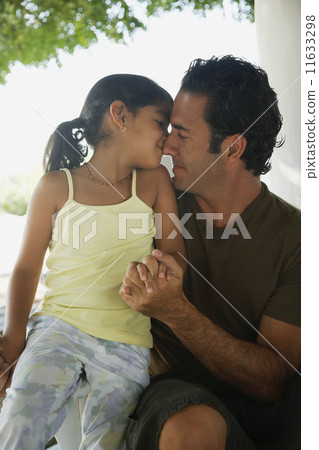 Hispanic father and daughter hugging 11633298