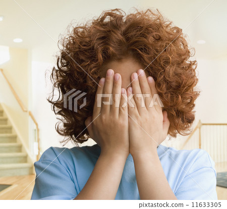 Mixed Race boy covering face 11633305