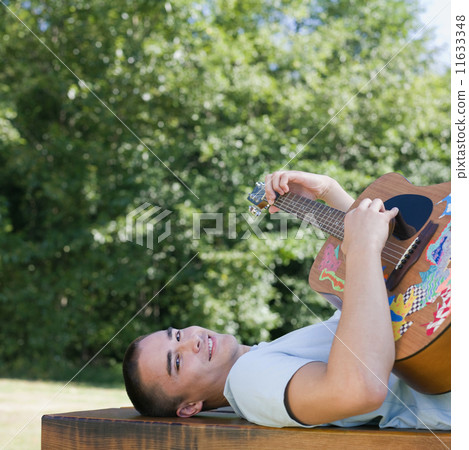 Mixed Race man playing guitar Mixed Race man playing guitar 11633348