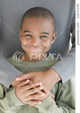 African boy getting hug from father 11633350