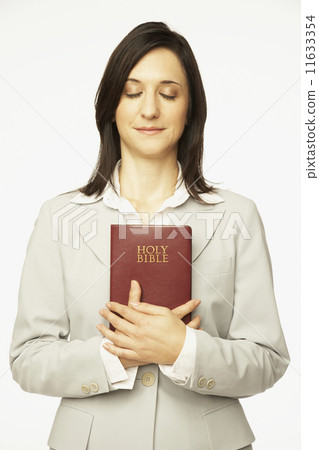 Hispanic woman holding Bible Hispanic woman holding Bible 11633354