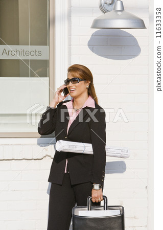 Asian businesswoman talking on cell phone Asian businesswoman talking on cell phone 11633358
