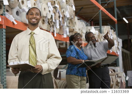 African American sales representative in carpet warehouse 11633369