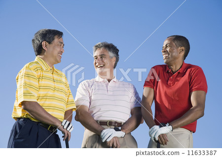 Multi-ethnic men holding golf clubs 11633387