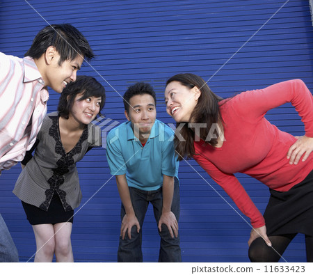 Group of friends in huddle next to building 11633423