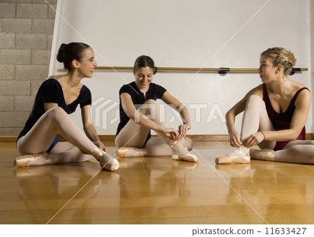 Hispanic female ballet dancers talking 11633427