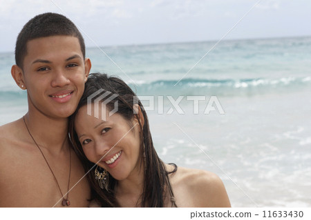 Multi-ethnic couple at beach Multi-ethnic couple at beach 11633430