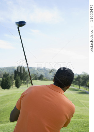 African man holding golf club 11633475