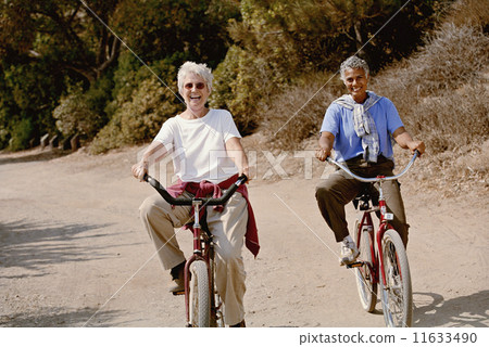 Multi-ethnic senior women riding bicycles Multi-ethnic senior women riding bicycles 11633490